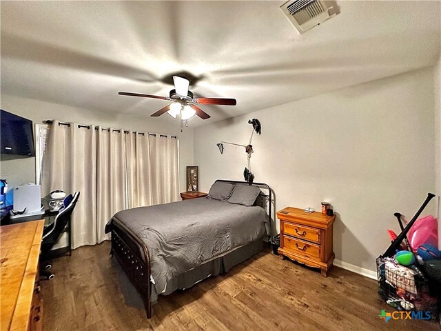 bedroom with dark wood-type flooring and ceiling fan