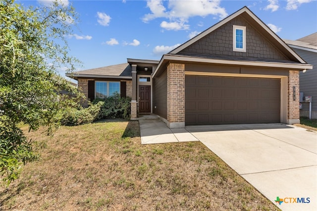 view of front of property with a garage and a front lawn