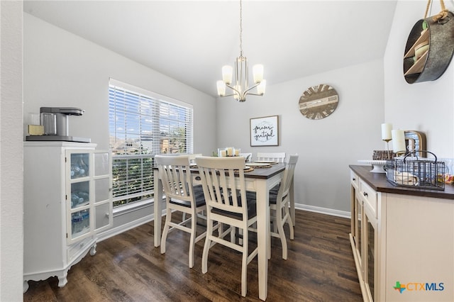 dining area featuring dark hardwood / wood-style flooring and a notable chandelier