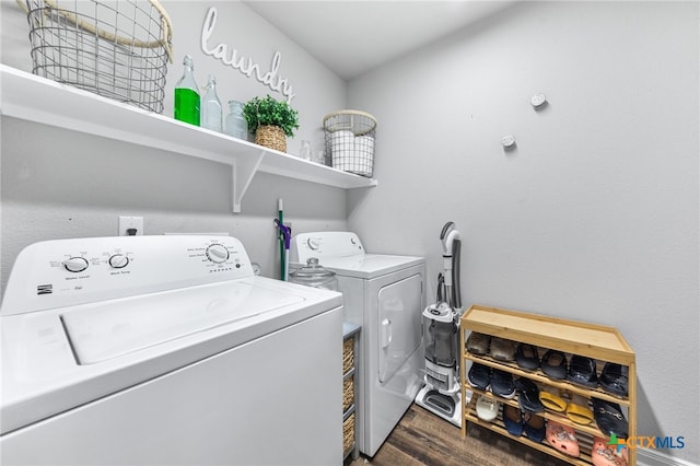 clothes washing area featuring dark wood-type flooring and washing machine and clothes dryer