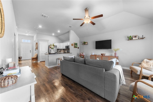 living room with ceiling fan, dark hardwood / wood-style floors, sink, and lofted ceiling