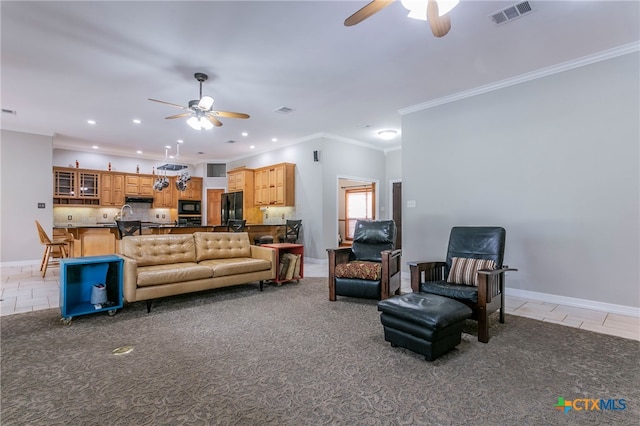 living room featuring light carpet, ceiling fan, and crown molding