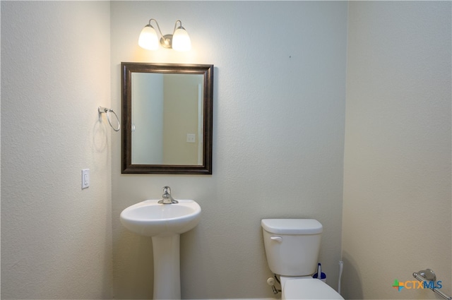 bathroom featuring sink and toilet