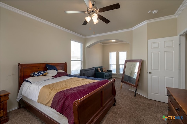 carpeted bedroom featuring crown molding and ceiling fan