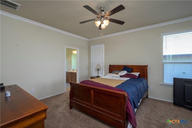 carpeted bedroom with ornamental molding, ceiling fan, and ensuite bath