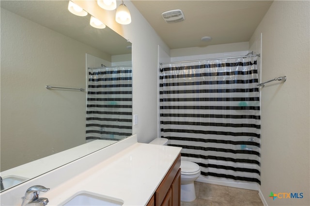 bathroom featuring walk in shower, vanity, and toilet