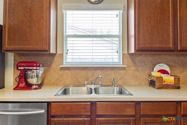 212 Nairm Ln, Temple, TX 76502 - kitchen with dishwasher, a sink, light countertops, tasteful backsplash, and brown cabinetry