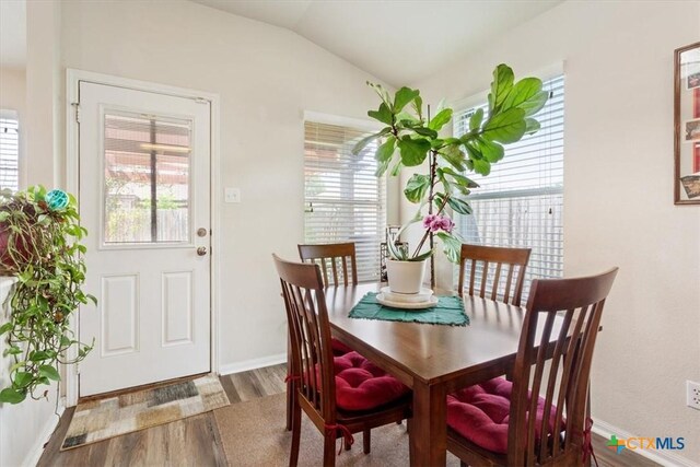 212 Nairm Ln, Temple, TX 76502 - dining room with wood finished floors, lofted ceiling, and baseboards
