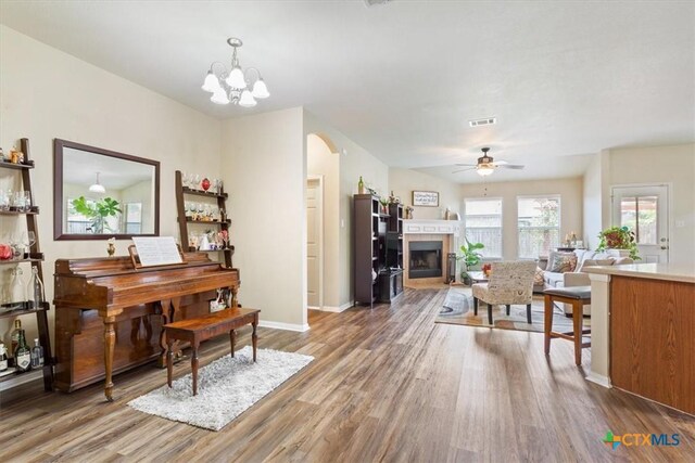 212 Nairm Ln, Temple, TX 76502 - living area featuring wood finished floors, arched walkways, ceiling fan, and baseboards
