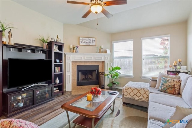 212 Nairm Ln, Temple, TX 76502 - living area featuring wood finished floors, a ceiling fan, and a tile fireplace