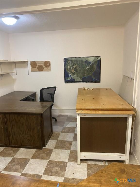 office area featuring baseboards and tile patterned floors