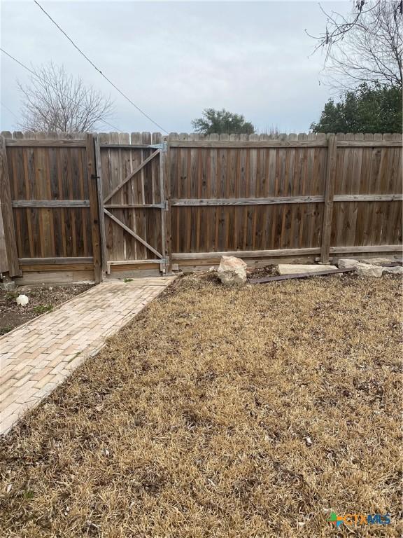 view of yard with a gate and fence