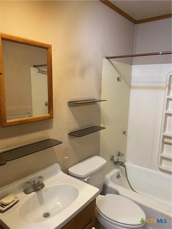 bathroom with toilet,  shower combination, vanity, and crown molding