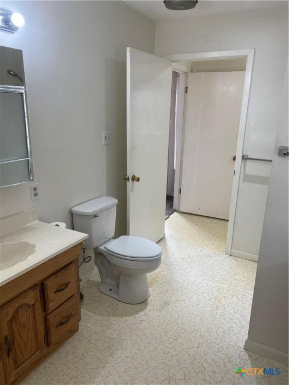 bathroom featuring vanity, toilet, and tile patterned floors