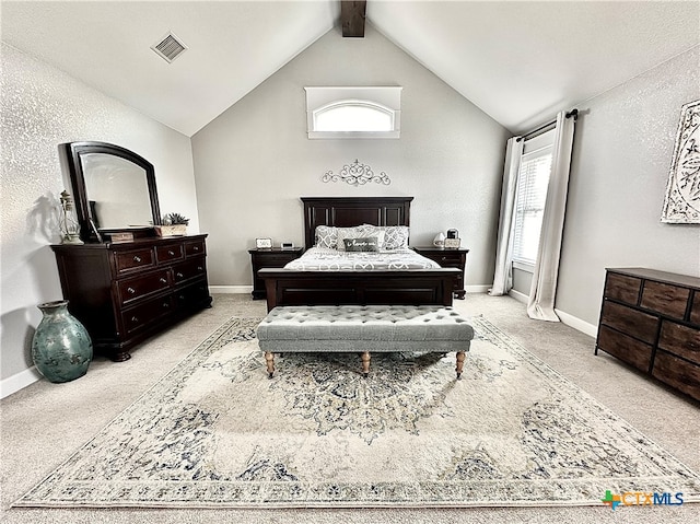 carpeted bedroom with lofted ceiling with beams