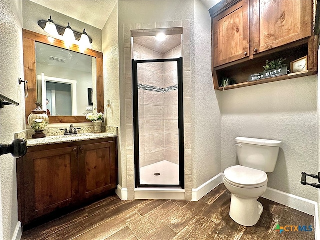 bathroom featuring walk in shower, wood-type flooring, toilet, and vanity