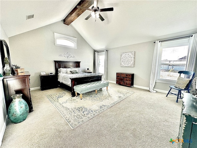 carpeted bedroom with vaulted ceiling with beams, ceiling fan, and a textured ceiling