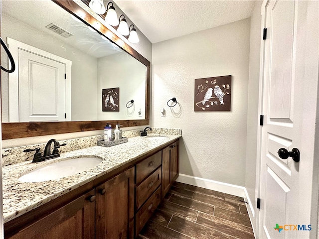 bathroom featuring vanity and a textured ceiling