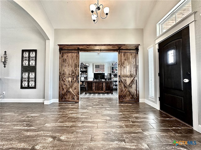 foyer featuring a textured ceiling and an inviting chandelier