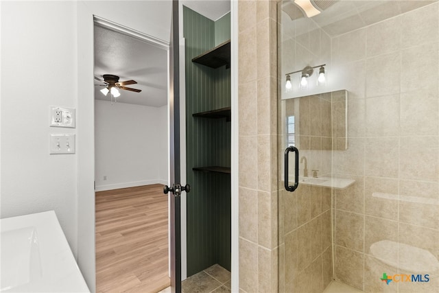 bathroom featuring an enclosed shower, vanity, ceiling fan, and hardwood / wood-style flooring