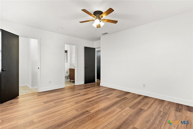 unfurnished bedroom with ceiling fan, light wood-type flooring, and ensuite bath