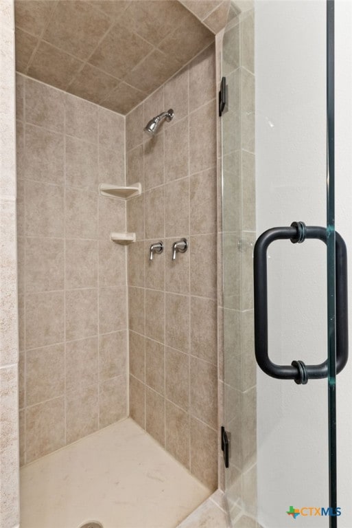 bathroom with tiled shower