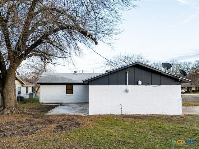 view of home's exterior with a patio and a lawn