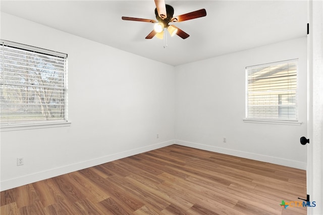 empty room featuring hardwood / wood-style flooring and ceiling fan