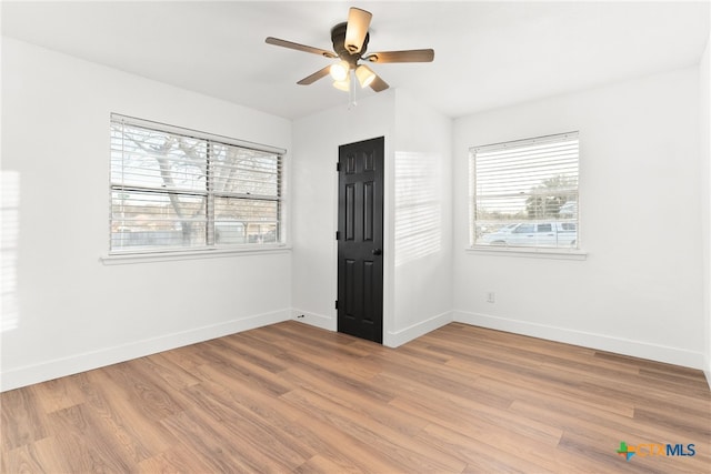 unfurnished room featuring ceiling fan and light hardwood / wood-style flooring