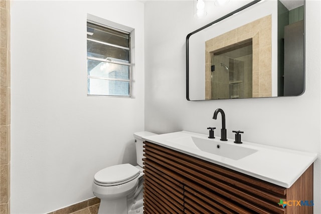 bathroom featuring walk in shower, tile patterned floors, vanity, and toilet