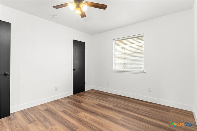 spare room with wood-type flooring and ceiling fan