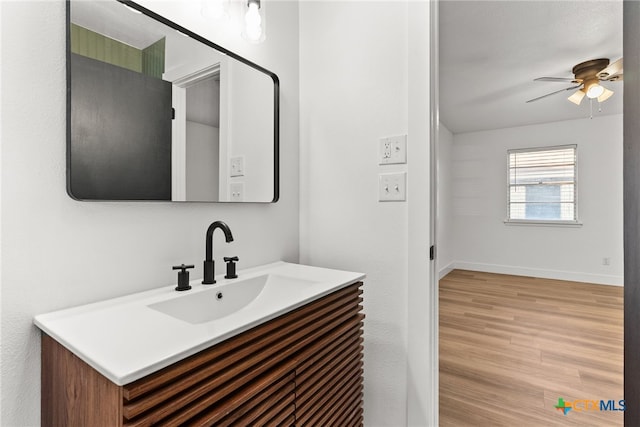 bathroom featuring hardwood / wood-style floors, vanity, and ceiling fan