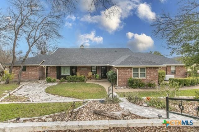 ranch-style home with a front lawn