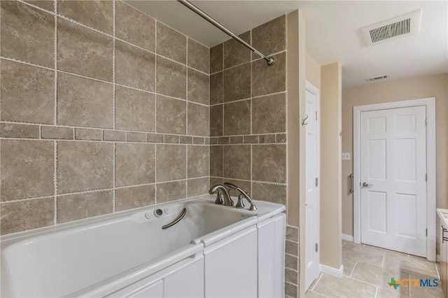 bathroom with tile patterned floors, visible vents, a washtub, baseboards, and a shower