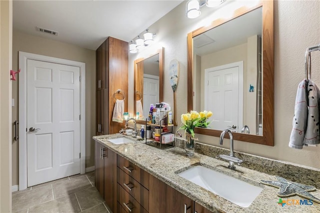 bathroom featuring tile patterned flooring and vanity