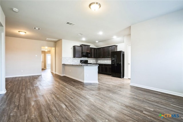 kitchen with black appliances, visible vents, and open floor plan