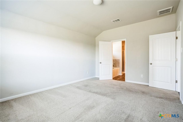 unfurnished bedroom with carpet, visible vents, and baseboards