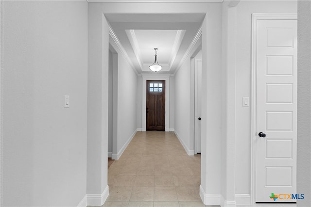 entryway with light tile patterned floors and ornamental molding