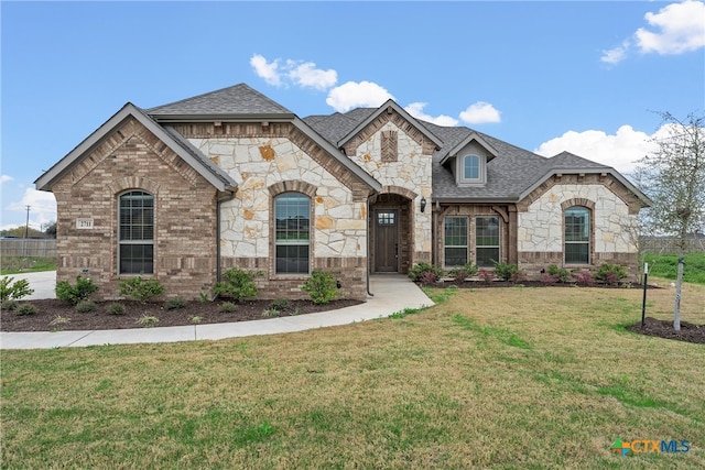 french provincial home with a front yard