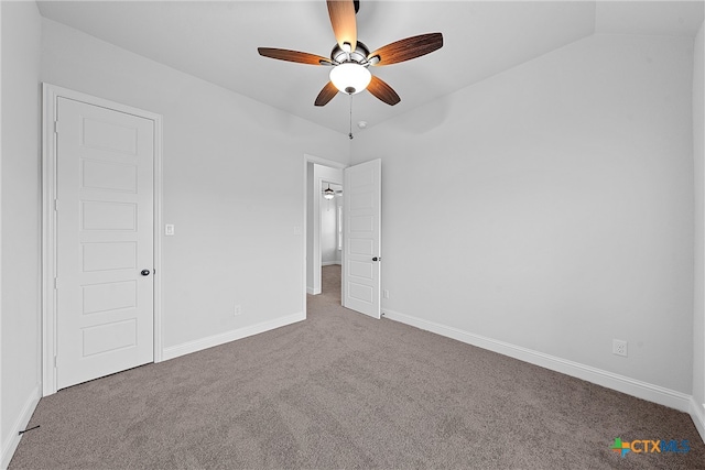 unfurnished bedroom featuring ceiling fan, vaulted ceiling, and carpet floors