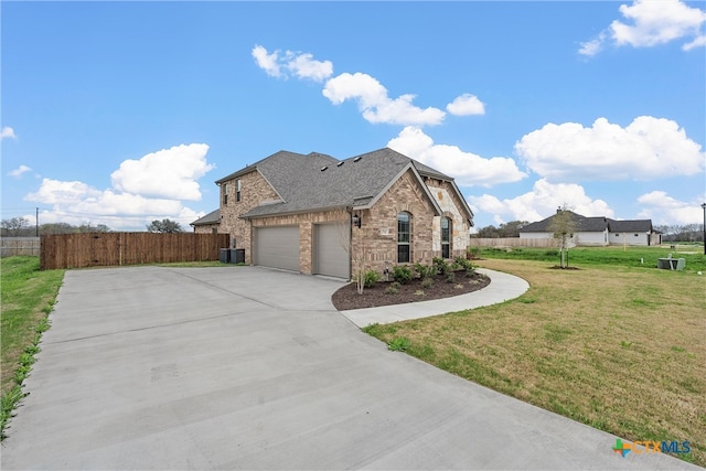 view of side of home with a garage, cooling unit, and a yard