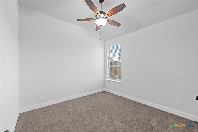 carpeted spare room featuring ceiling fan