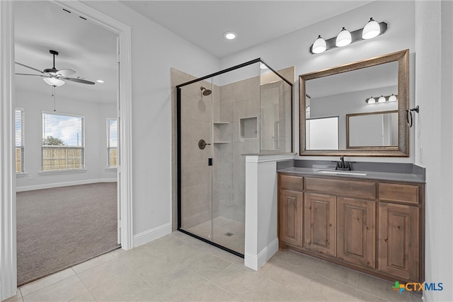 bathroom with vanity, a shower with shower door, tile patterned floors, and ceiling fan