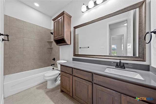 full bathroom with toilet, tiled shower / bath combo, vanity, and tile patterned flooring