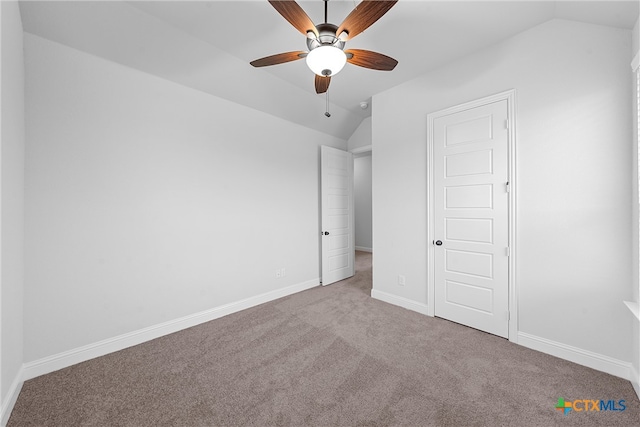 unfurnished bedroom featuring ceiling fan, light carpet, and lofted ceiling