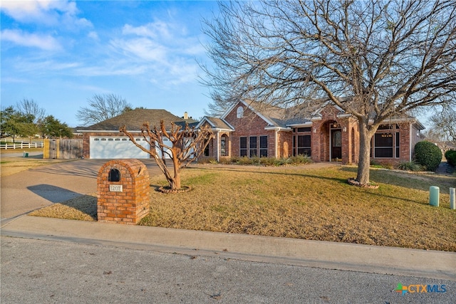 ranch-style house with a garage and a front yard