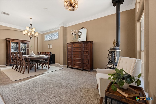 dining space with ornamental molding, carpet, a wood stove, and a chandelier