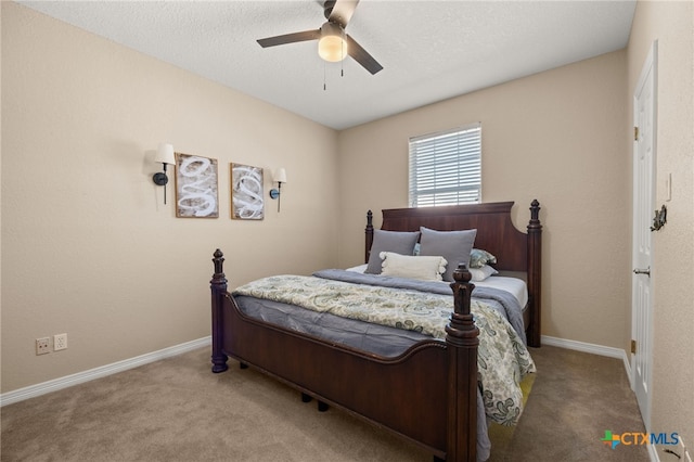 carpeted bedroom with a textured ceiling and ceiling fan