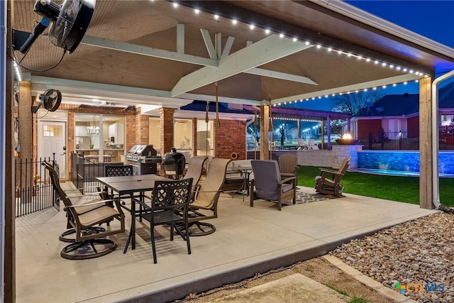 patio at twilight featuring area for grilling