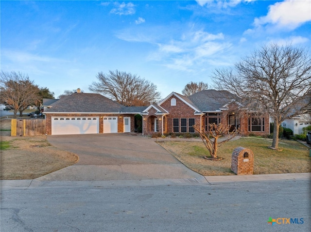 ranch-style home with a garage and a front lawn